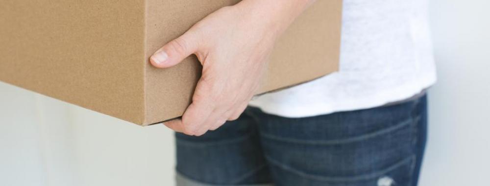 woman holding a cardboard moving box