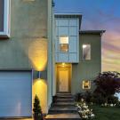 front of a home at dusk with the porch light on