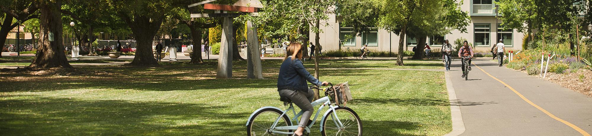 woman biking around uc davis campus