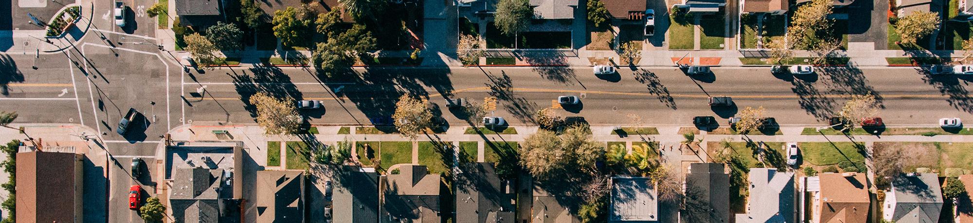 aerial image of a neighborhood street and rows of houses